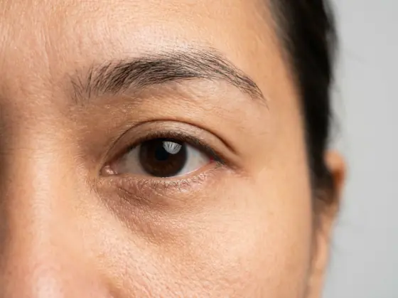 Downturned eye shape: outer corner lower than the inner, so the line slopes down