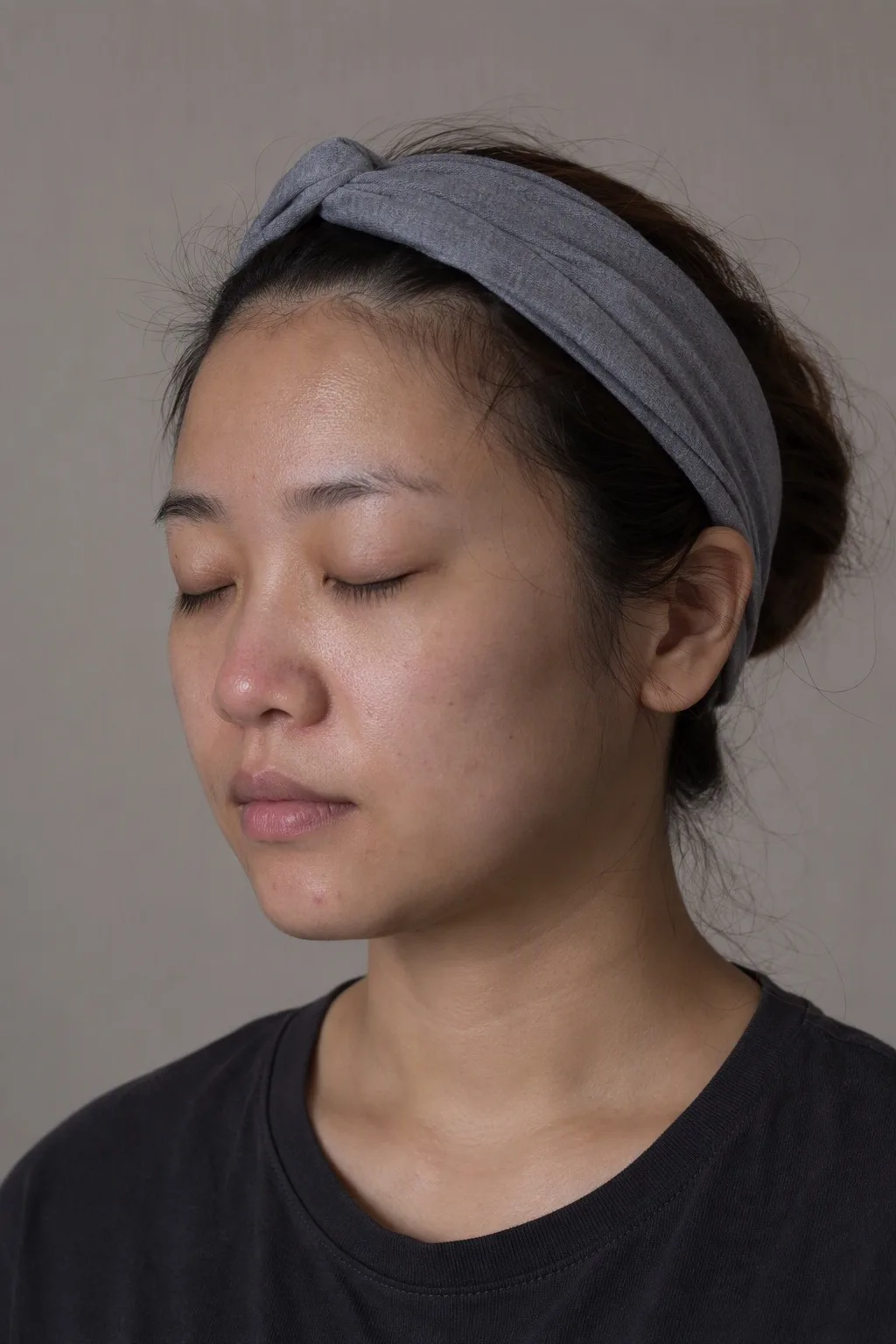 Woman in profile with natural, un-retouched skin, eyes closed